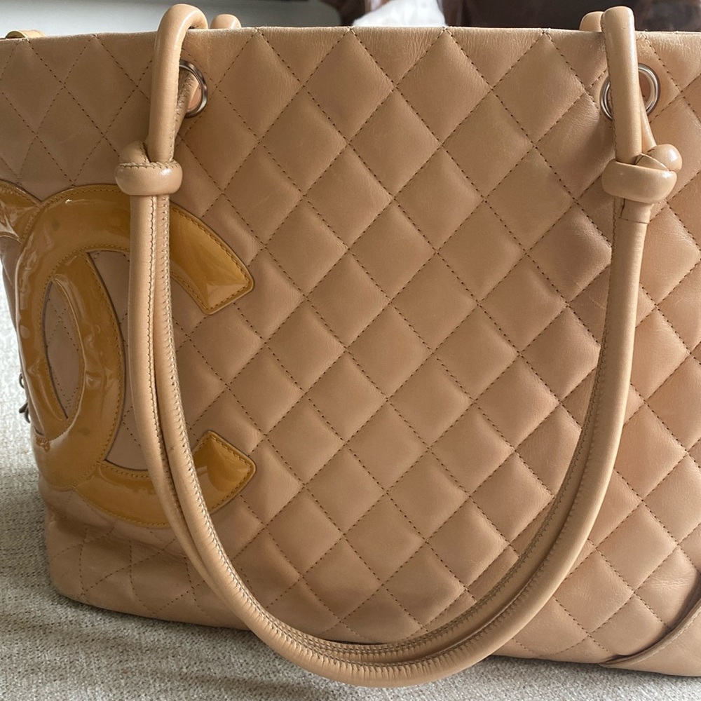 Authentic cream Chanel medium tote. Normal wear and tear
